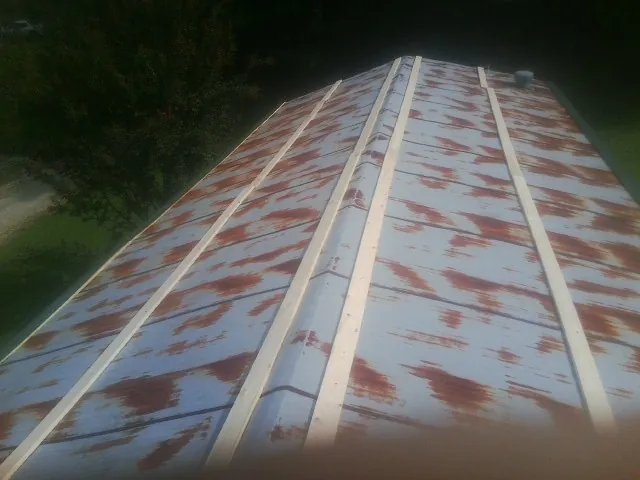 Rusted metal roof panels with new wood purlins before replacement — Storm Damage Roof Repair in West Bloomfield by Roofing Brothers