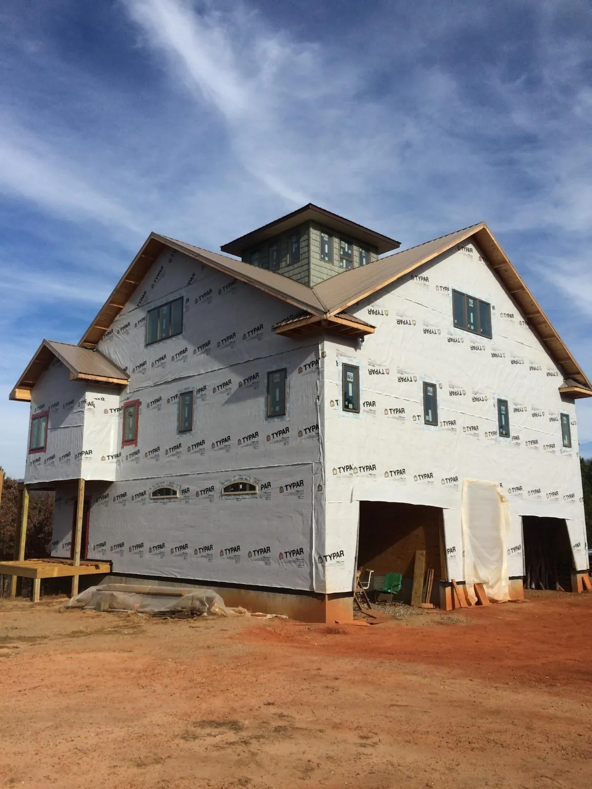 New two story house under construction with a cupola and gabled roofs in West Bloomfield